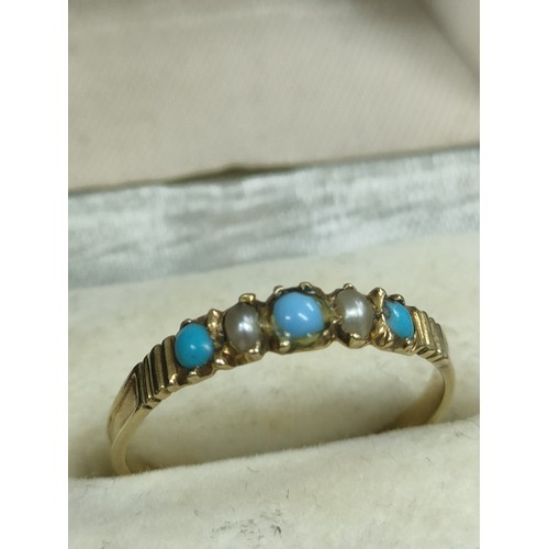 45a - Not hallmarked 9ct gold ring set with blue stone and pearl effect stone setting . Tested .