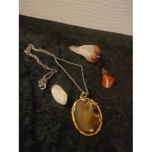 58 - Selection of early large quartz pendants together with agate pendant with chain.