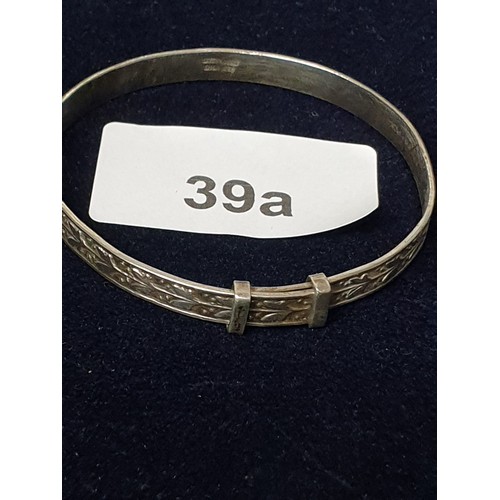 39A - Silver Childs Expanding Bangle With Raised Floral Decoration