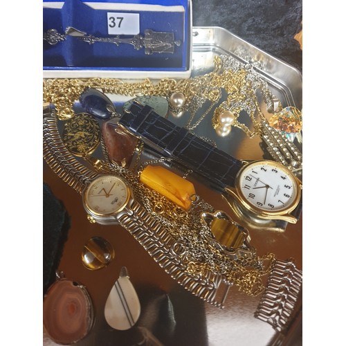 37 - Tray Of Costume With Pocket Watch, Military Cap Badge, Large Celtic Pendant , White Metal Spoon etc