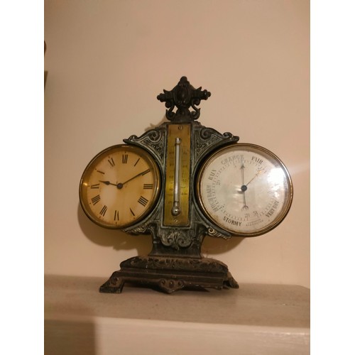 29 - A 19th century cast iron clock/barometer with brass centre thermometer ( needs attention on one leg)