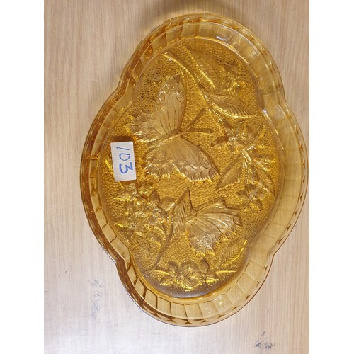 103 - An Art Deco Amber Glass Butterfly Pattern Dressing Table Set Comprising Tray, 2 Candle Sticks , Powd... 