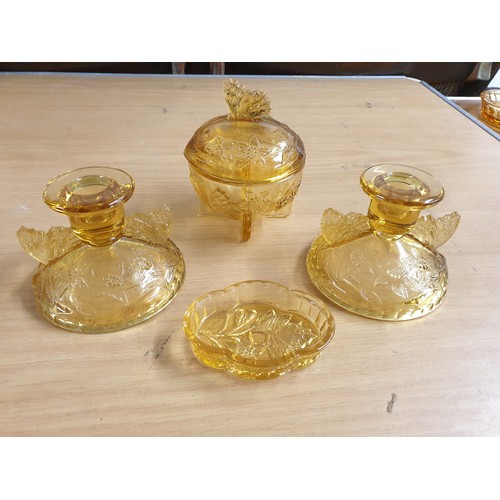 103 - An Art Deco Amber Glass Butterfly Pattern Dressing Table Set Comprising Tray, 2 Candle Sticks , Powd... 