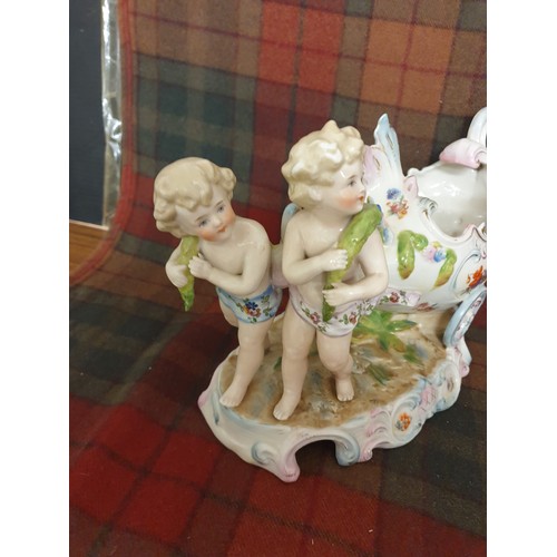 84 - A 19th century German Porcelain Sweet Meat Dish In Form Of 2 Cherubs Pulling a 2 Wheeled Cart All Ha... 