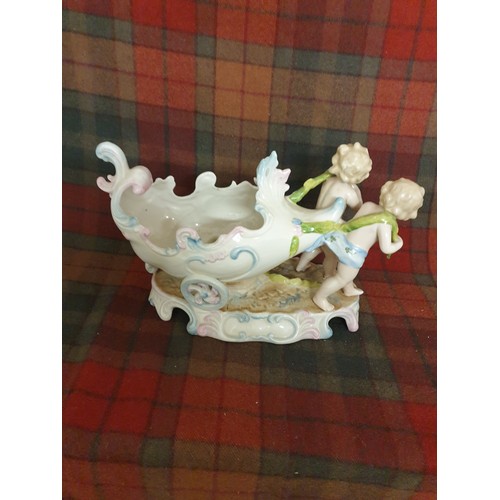 84 - A 19th century German Porcelain Sweet Meat Dish In Form Of 2 Cherubs Pulling a 2 Wheeled Cart All Ha... 