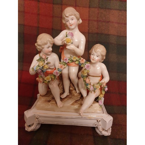 88 - A 19th century porcelain study of 3 Cherub s On Stand With Garlands Of Flowers Crown Marking With M