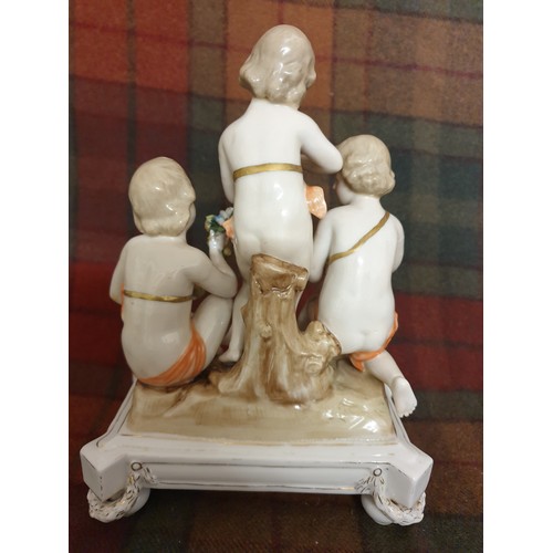 88 - A 19th century porcelain study of 3 Cherub s On Stand With Garlands Of Flowers Crown Marking With M