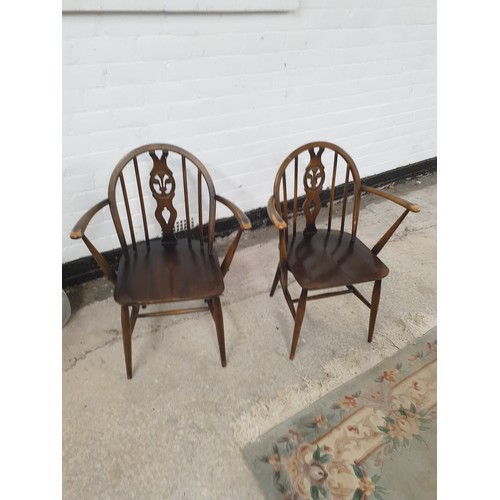 200 - A Set Of 6 Ercol Wheel Back Fleur De Leigh Dining Chairs To Include 2 Carvers