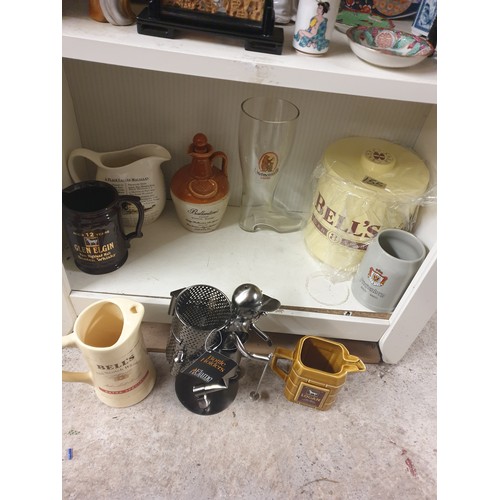 155 - A Shelf Of Pub Advertising Water Jugs , Bells Ice Bucket, Glass Boot, Bottle Holder etc