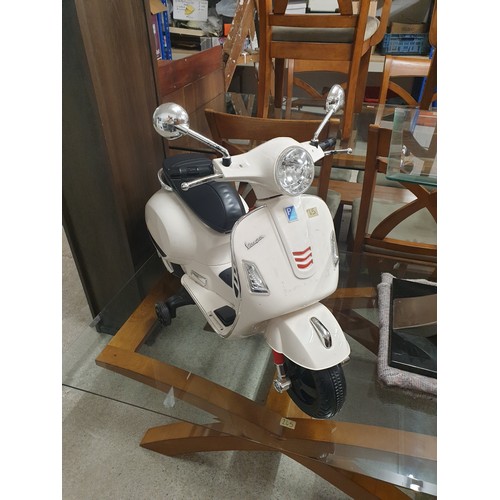 65 - A Childs Vespa Ride On Vehicle With Charger (Working order)