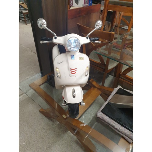 65 - A Childs Vespa Ride On Vehicle With Charger (Working order)