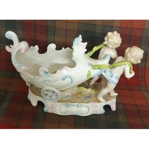 92 - A 19th century German Porcelain Sweet Meat Dish In Form Of 2 Cherubs Pulling a 2 Wheeled Cart All Ha... 