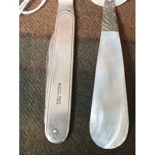 31 - Solid silver hall marked letter opener along with silver & mother of pearl spoon