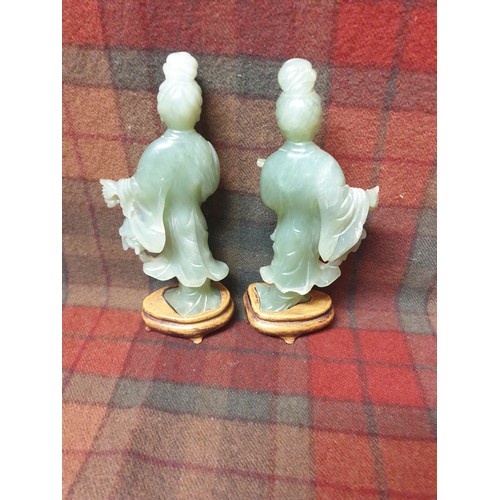 73 - A Pair of Chinese Jade statues on hard wood stands 20cms Tall