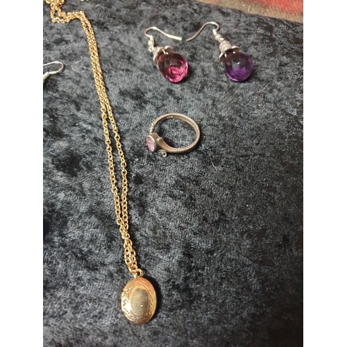 27 - A collection of silver earrings & Silver purple stone ring along with yellow metal chain marked 777,... 