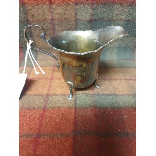 13 - A silver hall Birmingham marked cream jug makers mark rubbed [64.80grams]