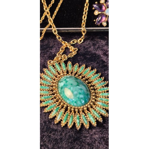 50G - A collection of four beautiful necklaces with pendants; opal style pendant with chain, green stone s... 