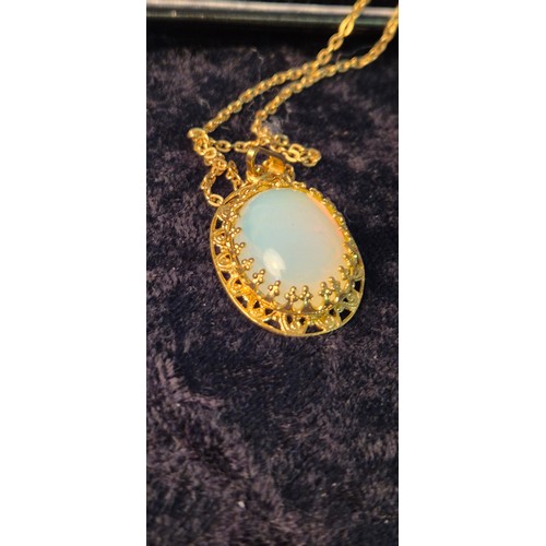 50G - A collection of four beautiful necklaces with pendants; opal style pendant with chain, green stone s... 