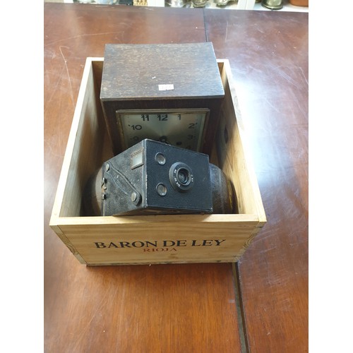 223 - A Wooden Advertising Crate With Bowling Boules, Clock And Vintage Camera