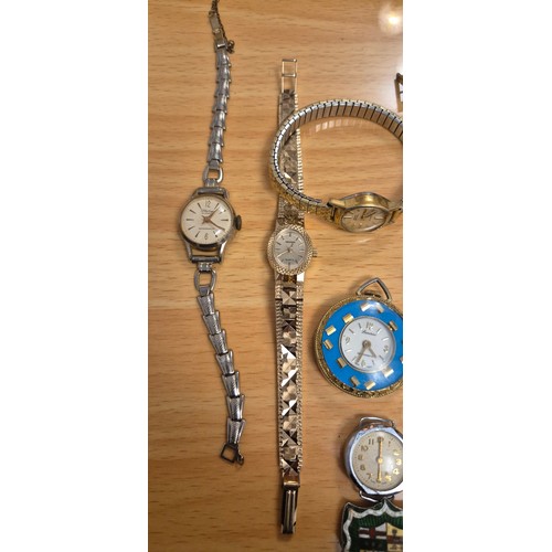 66 - A Colelction of antique & Vintage Ladies wrist watches together with Silver sheild badge