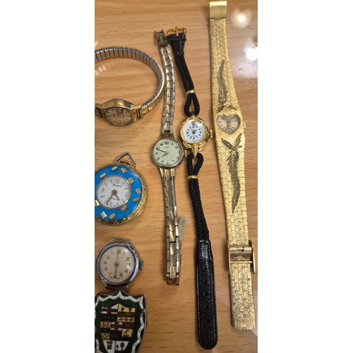 66 - A Colelction of antique & Vintage Ladies wrist watches together with Silver sheild badge