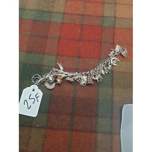 25F - Silver Charm Bracelet With 23 Charms Weight 55.31g Needs Securing Clasp