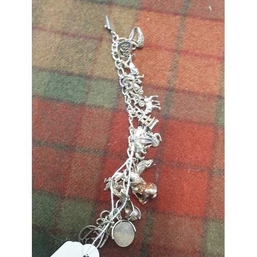 25F - Silver Charm Bracelet With 23 Charms Weight 55.31g Needs Securing Clasp