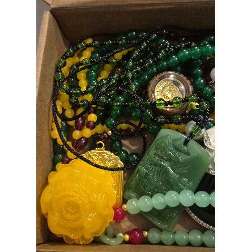 45 - Box of Oriental jewellery. Amulets necklaces, Jade Chinese hardstone bangle & chinese carved bracele... 