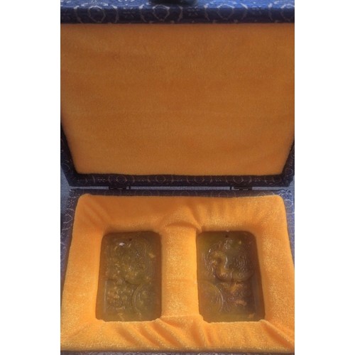 52 - Pair of Chinese Amulets Phoenix scene in silk fitted case.