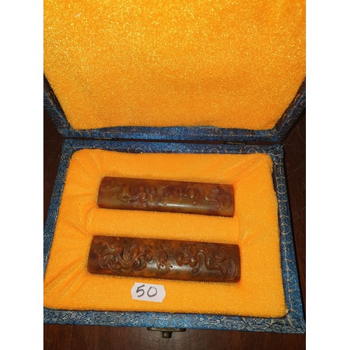 50 - Pair of Oriental soap stone panels in fitted silk box.