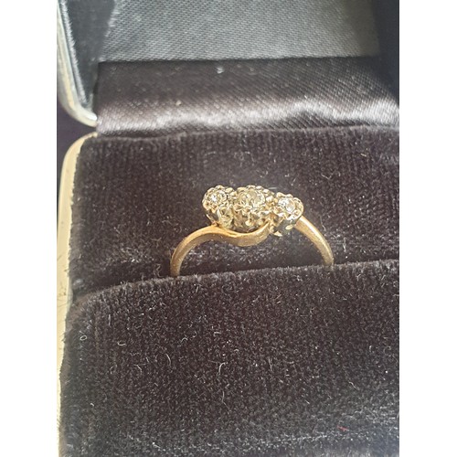 5 - 9ct Gold three stone Diamond Twist Ring. 2.1 grams. Size M
