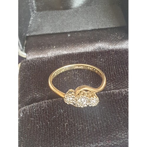 5 - 9ct Gold three stone Diamond Twist Ring. 2.1 grams. Size M