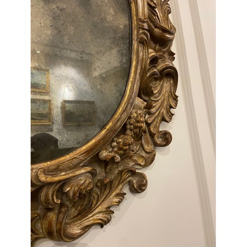 60 - Rare ovoid Italian gilt-wood mirror (18th Century). Dimensions: