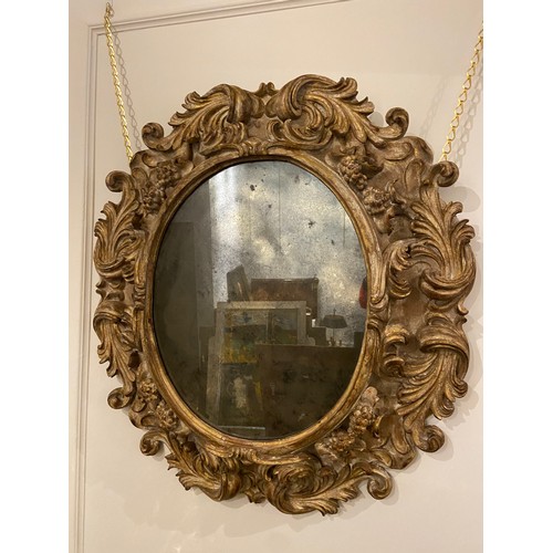 60 - Rare ovoid Italian gilt-wood mirror (18th Century). Dimensions: