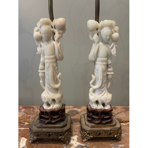 75 - Pair of 19th century Chinese White Jade figures of Lan Ts'ai-ho set upon carved wood bases, set upon... 