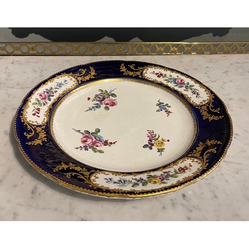 83 - An 18th Century Sevres Porcelain Plate with an indented ‘Sevres blue’ rim, gold gilding ... 