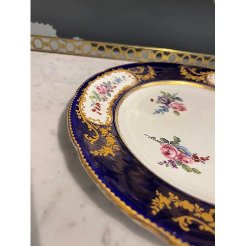 83 - An 18th Century Sevres Porcelain Plate with an indented ‘Sevres blue’ rim, gold gilding ... 