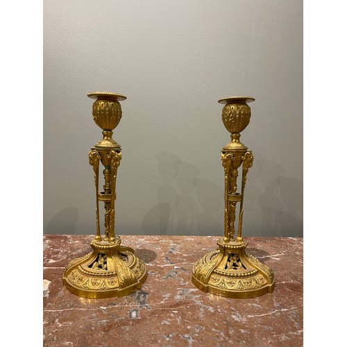 85 - A pair of Restauration ormolu candlesticks (circa 1820). Each with a pierced tripartite and vine-wra... 