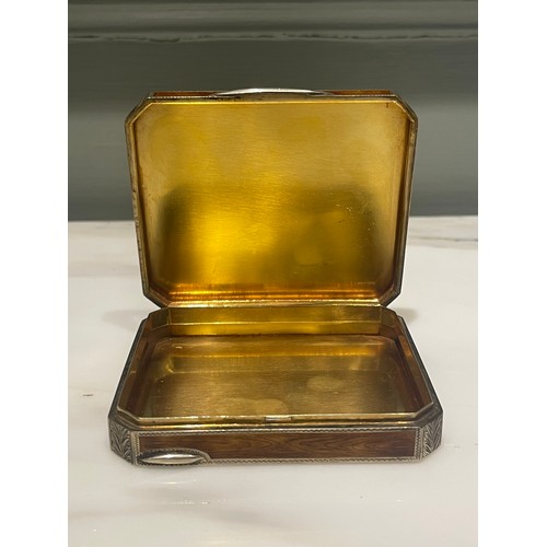 92 - An antique silver and enamel snuff box of rectangular form with canted corners decorated with amber ... 