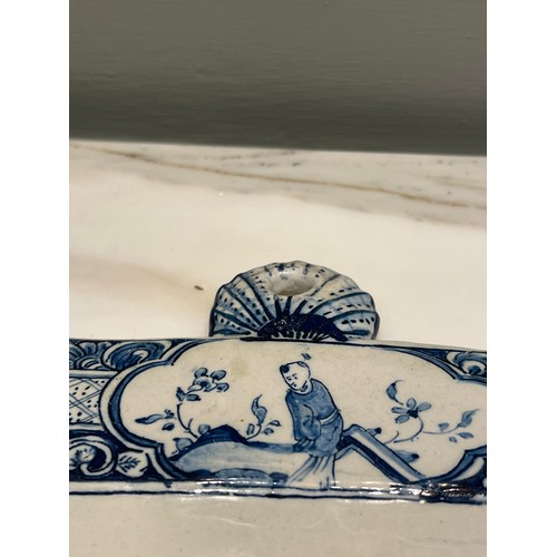 97 - A Dutch Delft blue and white rectangular genre plaque. Central marine landscape of port and figures ... 