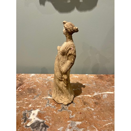 101 - A Hellenistic terracotta statuette of a woman wearing a chiton. Evidence of polychromy. Condyli... 