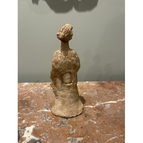 101 - A Hellenistic terracotta statuette of a woman wearing a chiton. Evidence of polychromy. Condyli... 