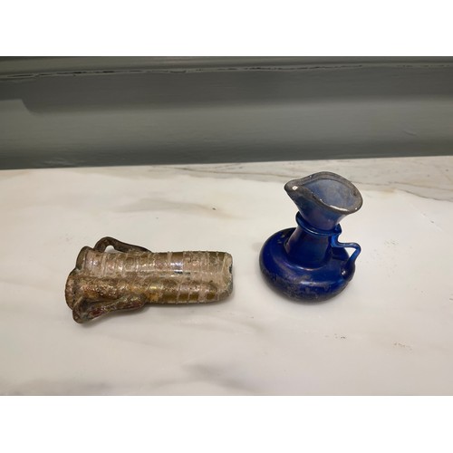 102 - A Roman blue glass vessel (a) and Roman glass miniature double-amphora (b).Condylis CollectionDimens... 