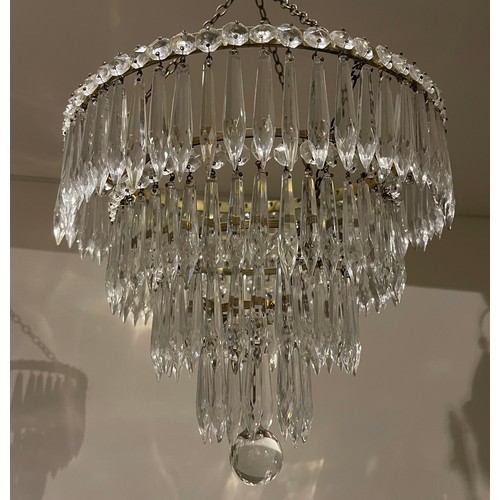 88A - A pair of 19th century cut-glass four-tiered chandeliers with spherical drop. With central brass lig... 