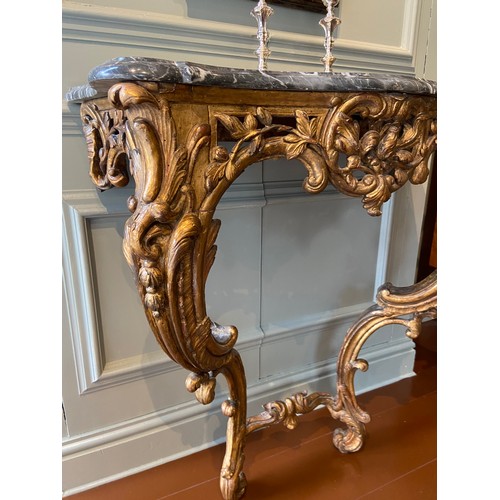 6 - Italian gilt-wood serpentine console table with later Bardiglio grey marble top. Mid-18th Century.Ex... 