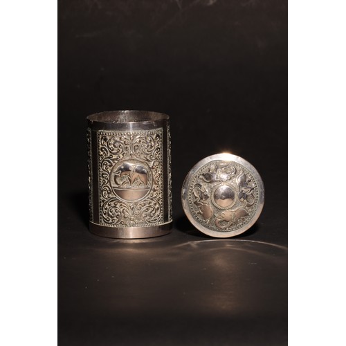 16 - An antique South Asian cylindrical silver casket and domed lid. Lid embossed with elephants.The body... 