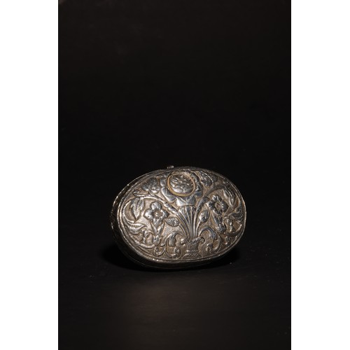 21 - An antique South Asian ovoid silver casket with lid.Profuse floral designs throughout.No hallmarks.P... 