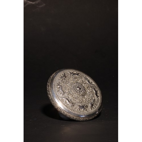 25 - An antique South Asian round, lidded silver casket.The lid with a frieze of running animals (elephan... 