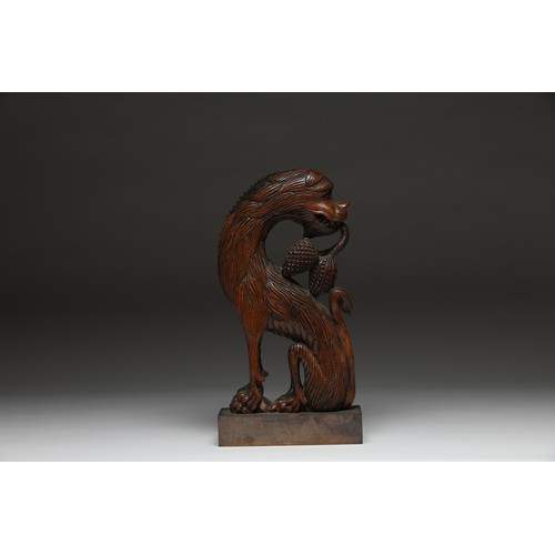 206 - To be sold without reserve.18th / 19th Century (?).A carved wooden griffin of stylised form on a lat... 