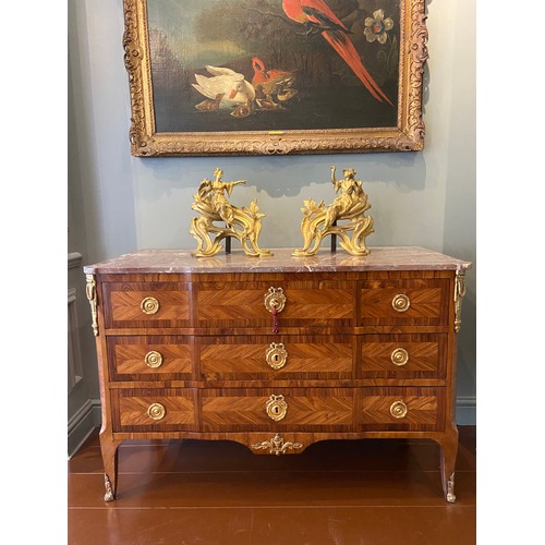 211 - A Louis XV ormolu-mounted kingwood and fruitwood commode with a rouge marble top and three long draw... 